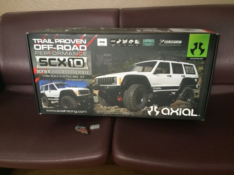1989 Ford Bronco - Box art for the Axial SCX10 II 2000 Jeep Cherokee 1/10th scale electric 4WD kit features two white Jeep Cherokees in an off-road setting.
