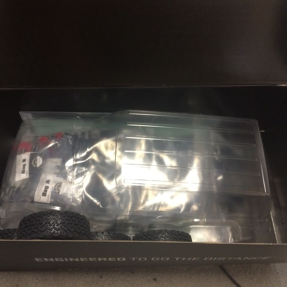 Clear plastic truck body and tires in a box with text 'ENGINEERED TO GO THE DISTANCE'