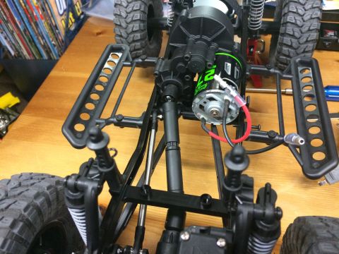 1989 Ford Bronco - Close-up of an RC car's chassis, highlighting the motor and drivetrain components.