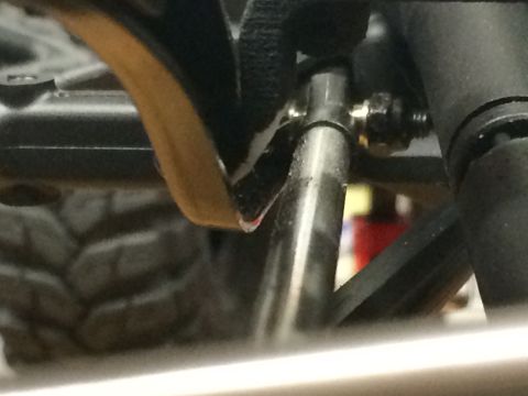 1989 Ford Bronco - Detail shot of RC car suspension linkage and a portion of a tire.