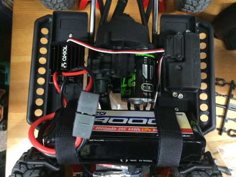 1989 Ford Bronco - The interior of an RC car displays its battery, motor, and electronic speed controller.