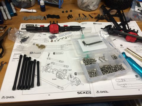 1989 Ford Bronco - Instructions and parts laid out for assembling an RC car, likely an Axial SCX10 model.
