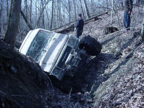 1992 Ford Bronco - A Suzuki Samurai has gone off-road and is stuck in a steep ditch.