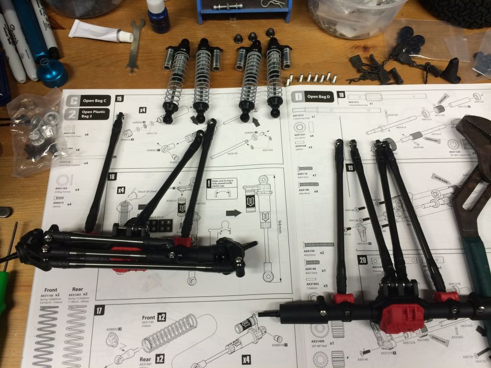 RC car suspension parts laid out on assembly instructions