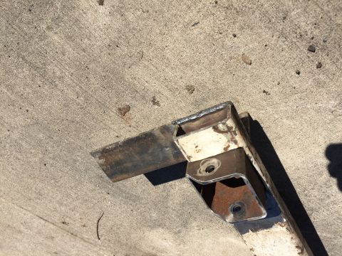 1996 Ford F-150 - A close-up view of a welded metal bracket, showing signs of rust and wear.