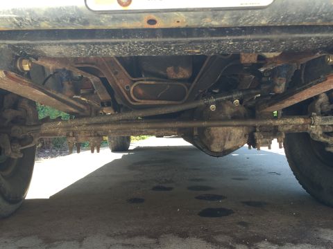 1996 Ford F-150 - The front axle and suspension of a 1996 Ford F-150 are visible from this underside perspective.