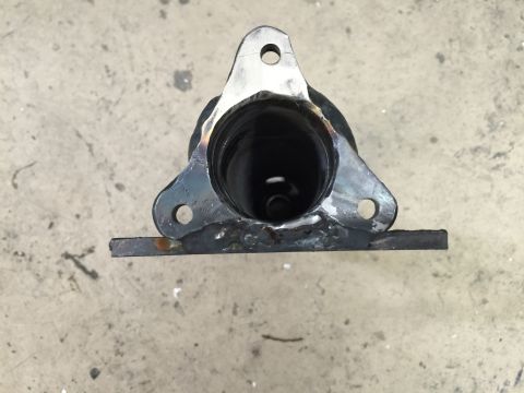 1965 Ford Mustang - A close-up view of an exhaust hanger bracket, showing its mounting flange and the opening for the exhaust pipe.