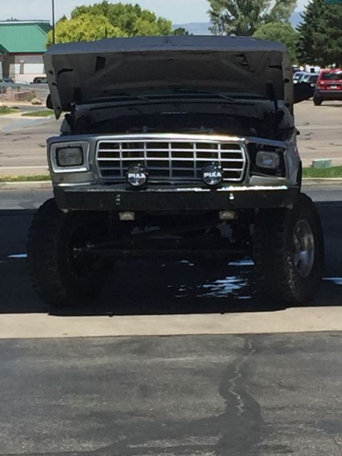 1979 Ford Bronco - Front view of a 1978 Ford Bronco, hood up, showing PIAA driving lights.