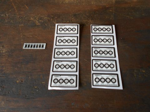1992 Ford Bronco - Multiple sheets of gauge cluster decals are laid out on a wooden surface.