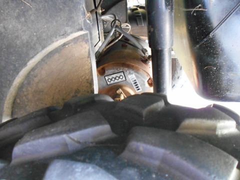 1992 Ford Bronco - A close-up view of a component on a vehicle, showing a label with circular markings.