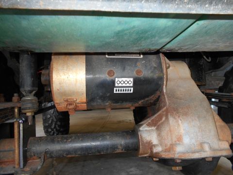 1992 Ford Bronco - Close-up view of a vehicle's undercarriage, highlighting mechanical components and signs of wear.