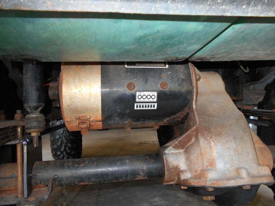 Vehicle underbody showing a motor and differential assembly, with visible rust and a Supermotors.net watermark