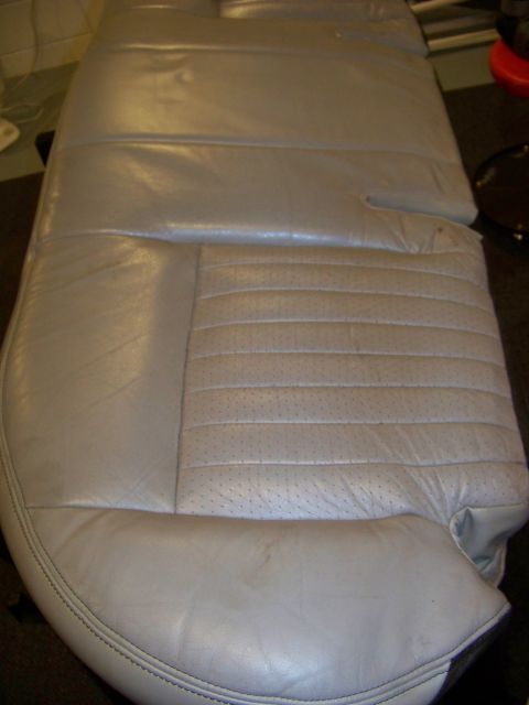 2001 Mercury Grand Marquis - A close-up view of a light gray leather car seat, showing its stitching and perforated sections.