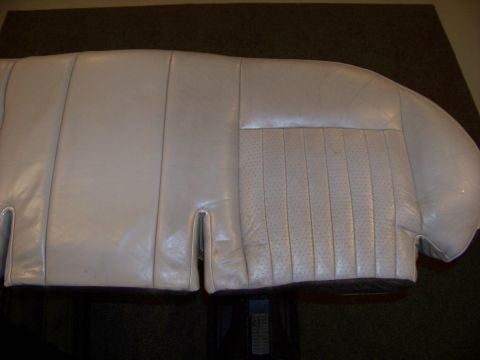 2001 Mercury Grand Marquis - Close-up of a light-colored leather car seat, a section with perforated inserts and vertical stitching.