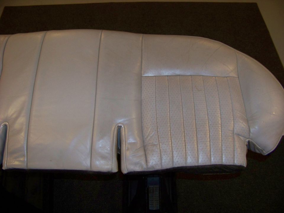 Light-colored leather car seat with perforated inserts