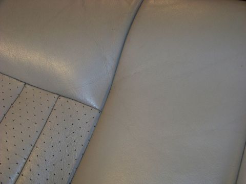 2001 Mercury Grand Marquis - Close-up view of the perforated and smooth leather upholstery on a vehicle's interior seats.