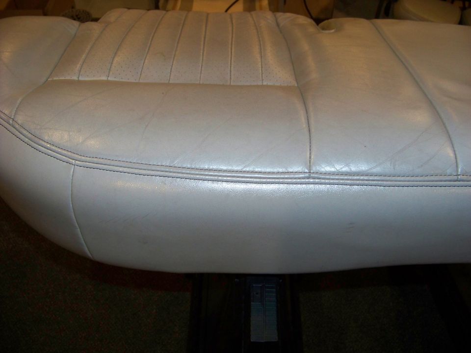 Light gray leather car seat with perforated inserts and double stitching