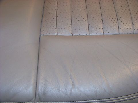 2001 Mercury Grand Marquis - Close-up view of the perforated and smooth leather upholstery on a car seat.