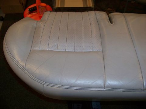 2001 Mercury Grand Marquis - A light gray leather car seat with perforated inserts and vertical stitching is shown.