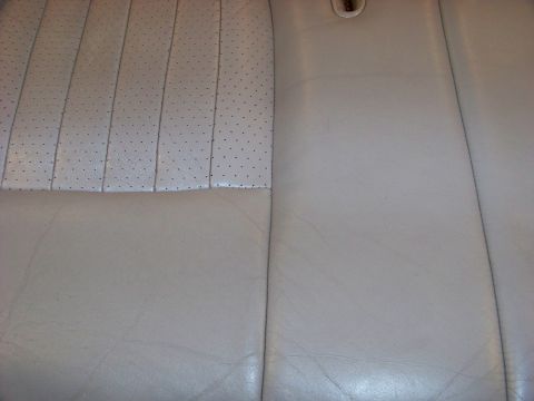 2001 Mercury Grand Marquis - Interior view of tan leather seats with perforated inserts, consistent with a 2001 Mercury Grand Marquis.