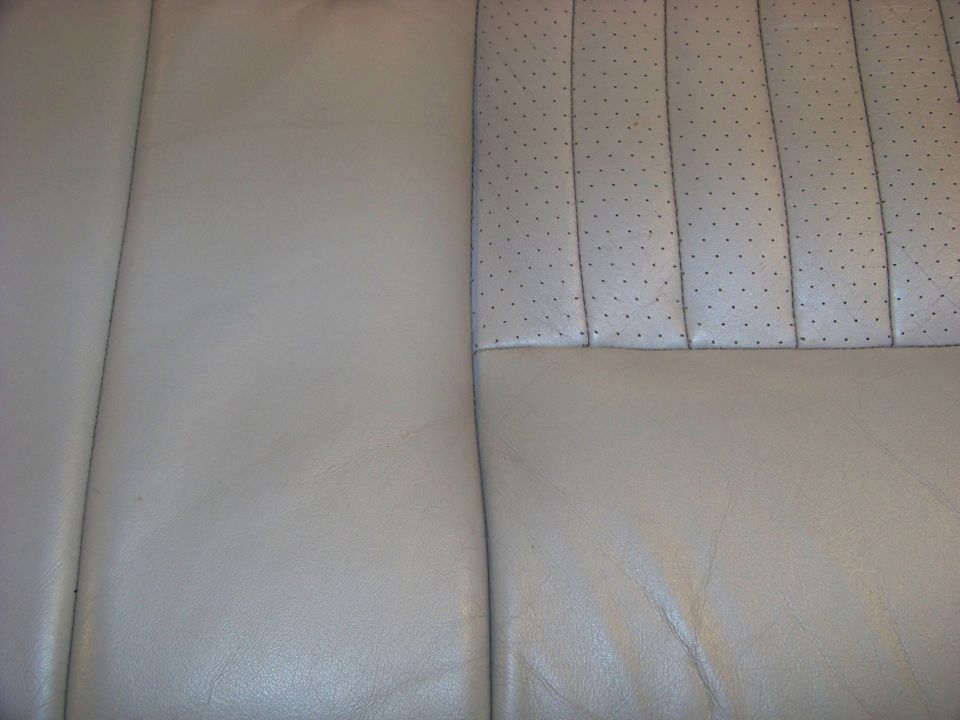 Close-up of perforated leather seat upholstery with stitching detail