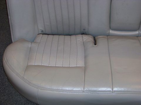 2001 Mercury Grand Marquis - Close-up of a light gray leather rear car seat, showing perforated inserts and stitching detail. The registry label may be incorrect.