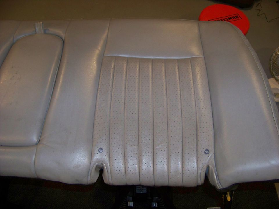 car seat with perforated center section and armrest