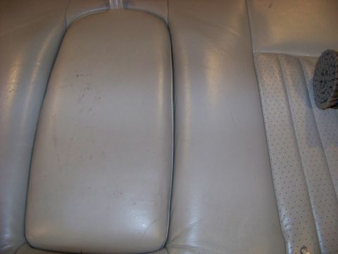 2001 Mercury Grand Marquis - Interior view of light gray leather car seats with a center armrest and perforated seat bottom.