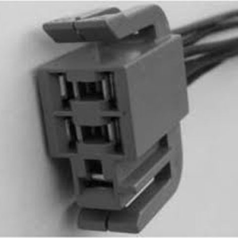 1990 Ford Bronco - A gray electrical connector with multiple wires is shown in a close-up view.