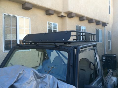 1987 Suzuki Samurai - This Suzuki Samurai is equipped with an aftermarket roof rack system, enhancing its utility for off-road adventures.