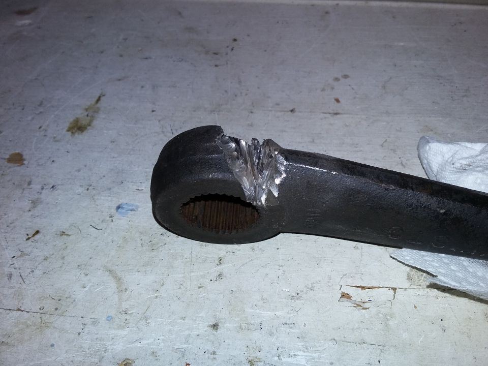 Damaged metal steering component with splines and visible weld marks