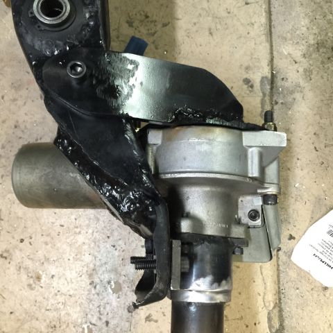 1965 Ford Mustang - A close-up view of a vehicle's steering gearbox and associated linkage components.