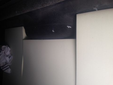 2001 Ford Ranger - The image shows a spare tire and storage compartment within a vehicle, with white panels and a cloth visible.