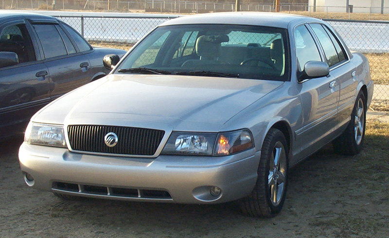 Silver Mercury Marauder sedan front three-quarter view parked on dry grass