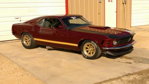 1970 Ford Mustang - Maroon 1970 Ford Mustang coupe with gold wheels and black hood stripes.