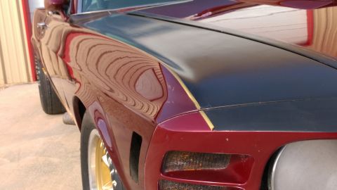 1970 Ford Mustang - The 1970 Ford Mustang displays a two-tone paint scheme with gold pinstriping.