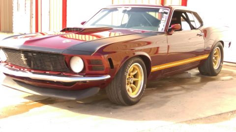 1970 Ford Mustang - A classic 1970 Ford Mustang is shown with a custom hood scoop and racing tires.