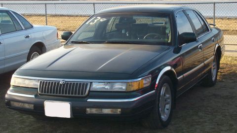 1993 Mercury Grand Marquis - Front view of a 1993 Mercury Grand Marquis parked outdoors next to another vehicle.