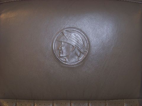 2001 Mercury Grand Marquis - Embossed Mercury emblem on a car's leather seat interior.