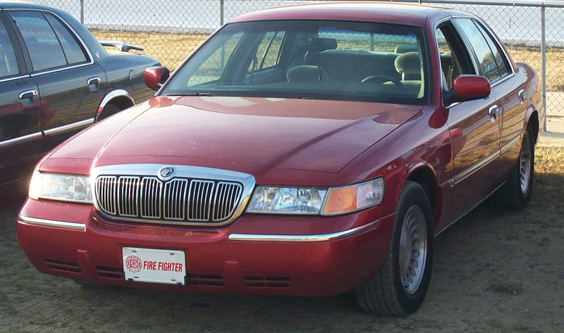 Dark red Mercury Grand Marquis sedan front three-quarter with Fire Fighter plate