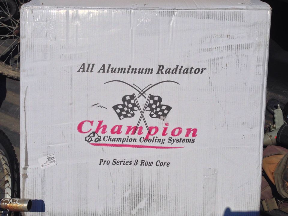 Cardboard box labeled 'All Aluminum Radiator', 'Champion Cooling Systems', 'Pro Series 3 Row Core'