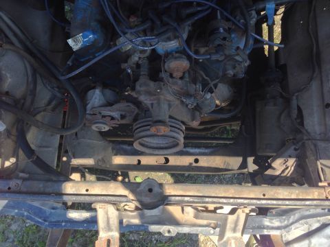 1979 Ford Bronco - A close-up view of the engine compartment, showing various mechanical parts and wiring.