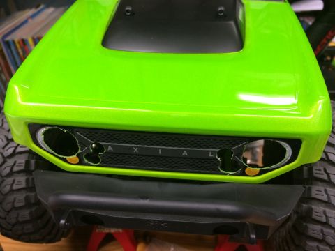 1989 Ford Bronco - Front view of a green RC car body with the brand name AXIAL visible on the grille.