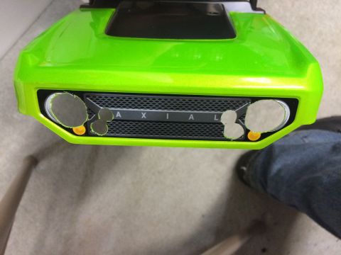 1989 Ford Bronco - Front view of a green vehicle body with a prominent AXIAL grille and cutouts for headlights.