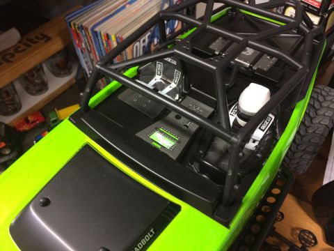 1989 Ford Bronco - Interior view of a bright green RC car, a roll cage, racing seats, and a detailed dashboard display.
