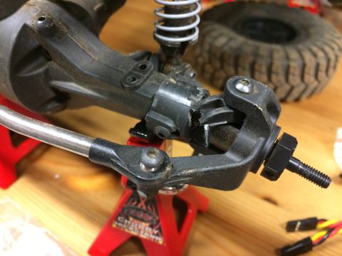 1989 Ford Bronco - Close-up view of an RC car's front axle assembly, showing suspension components and steering linkage.