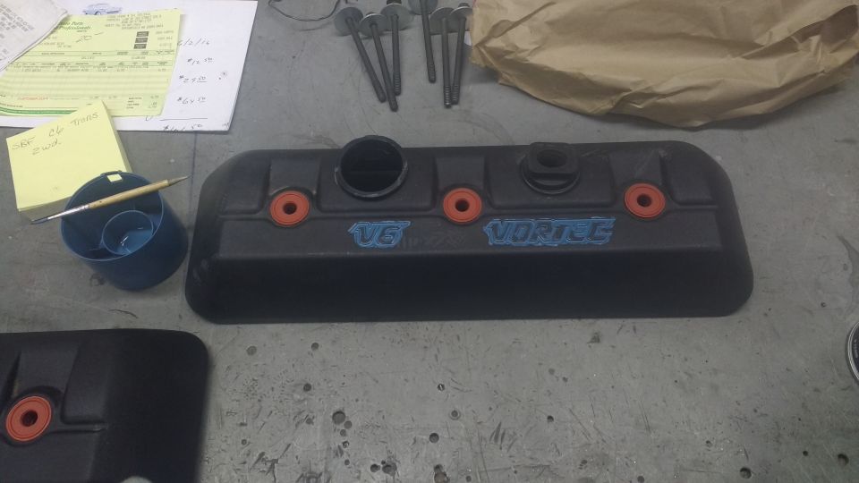 Black V6 Vortec engine cover with orange accents