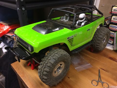 1989 Ford Bronco - This RC car features a detailed interior with racing seats and a roll cage, painted in a vibrant lime green.