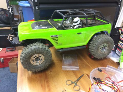 1989 Ford Bronco - RC rock crawler toy truck with "DEADBOLT" text on the hood and a driver figure inside.