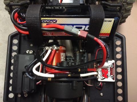 1989 Ford Bronco - Close-up of the internal electronics of an RC car, including battery and motor.